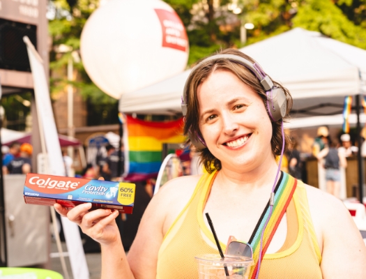 Woman at pride event holding Colgate