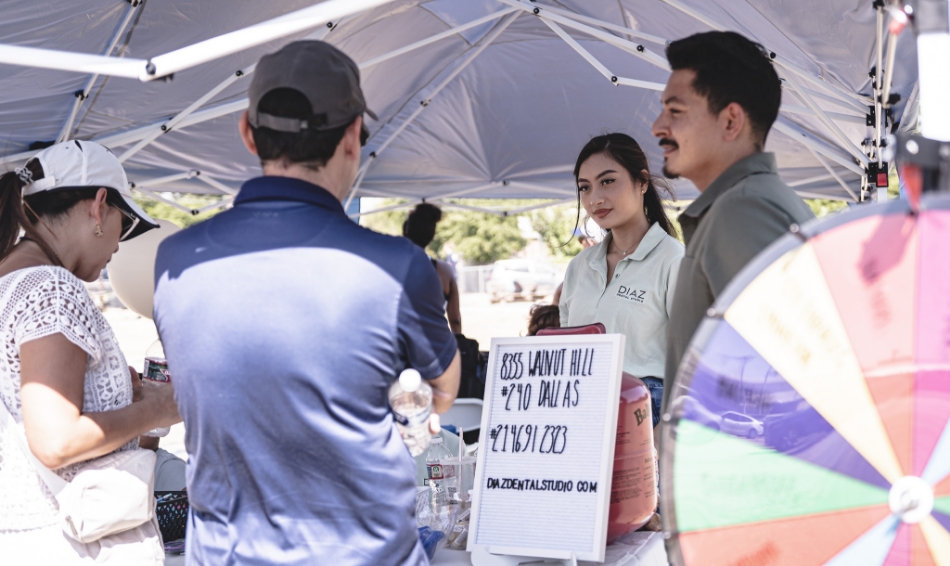 Dental team members talking to people at event