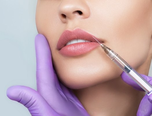 Close up of woman with smooth facial skin receiving Botox injection