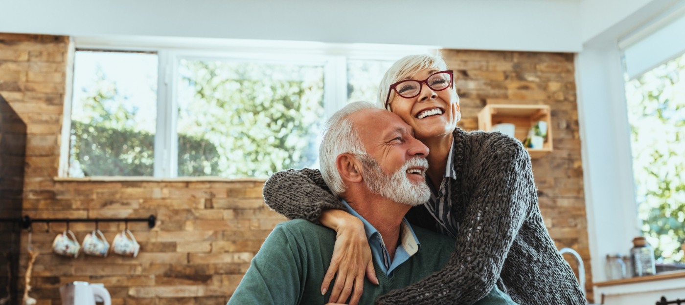 Woman hugging man in middle of living room