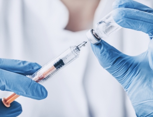 Close up of needle and bottle of antibiotics