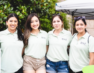 Dental team members standing together outside and smiling