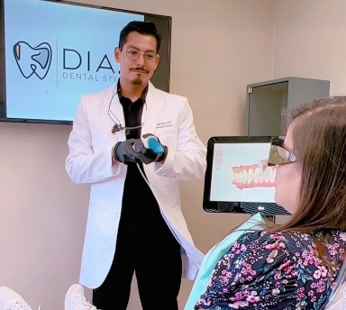 Dentist standing in front of female patient