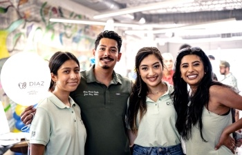 Dental team members standing in row and smiling