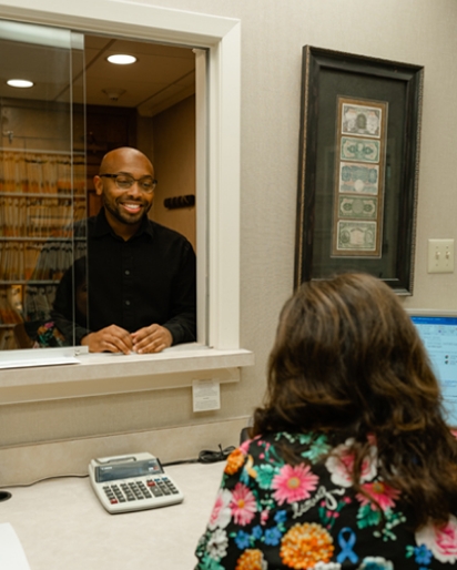 Man standing at window and smiling