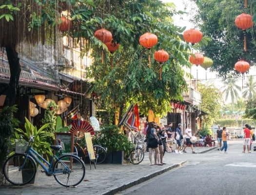 Shot of street with orange balloons in trees