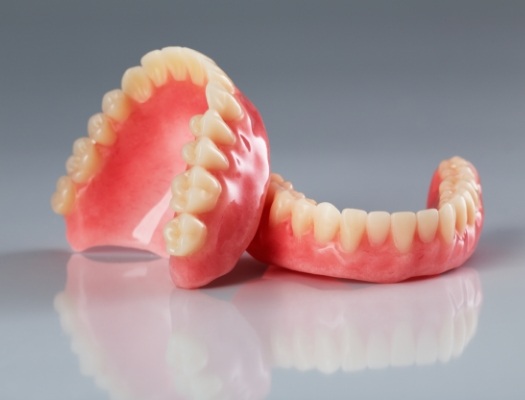 Close up of full dentures sitting against each other