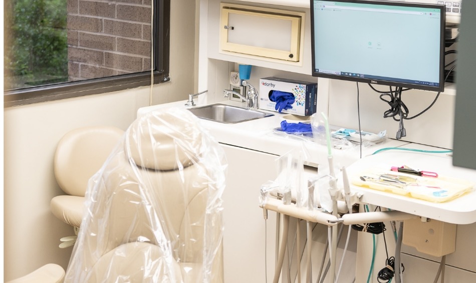 Dental chair in middle of dental treatment area